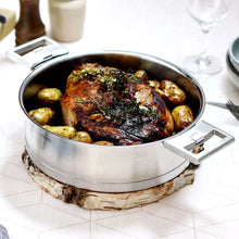 Stainless steel steamer pan with roasted chicken and side handles