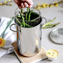 Stainless steel steamer pot with wire basket and asparagus inside