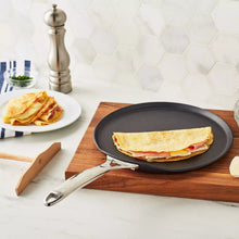 Nonstick crêpe pan with folded crepe on dark nonstick surface