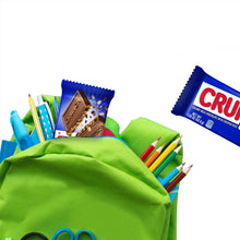 Crunch candy bars and wrappers in green tote bag with colored pencils