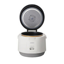 Open white rice cooker showing inner pot, heating plate, and control panel