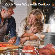 Rice cooker warmer on kitchen counter with family preparing food nearby