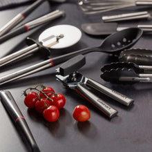 12-piece kitchen gadget set close-up with stainless tools, black handles, and tomatoes