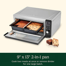 Cuisinart air fryer oven with 2-in-1 divider pan holding two baked items