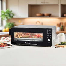 Cuisinart air fryer oven on countertop with open cooking door showing roasted food