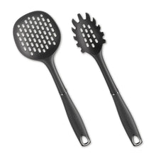 Pair of black silicone slotted cooking spoons with round perforated heads