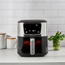 Compact stainless air fryer with black basket, digital display, and front pull handle
