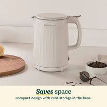 Cuisinart electric kettle, white, on countertop with handle and spout