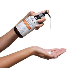 Pump bottle dispensing onto hand, with second palm underneath