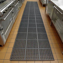 Long modular floor mat tiles with circular holes, dark gray, tightly fitted
