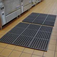 Modular floor mat tiles, dark gray with circular ventilation holes, interlocked