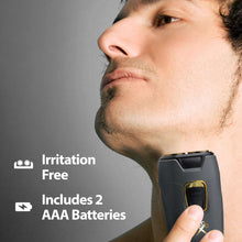 Dual rotary travel shaver held to face, dark gray body with gold power switch