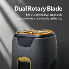 Dual rotary travel shaver head close-up, gold dual blades on dark gray body
