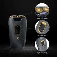 Dual rotary travel shaver showing two rotary blades and on/off button, dark gray body
