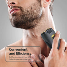 Dual rotary travel shaver in hand, dark gray body with gold power button
