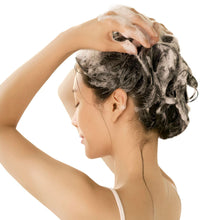 D'alba scalp shampoo in use: person lathering hair with foamy suds on scalp