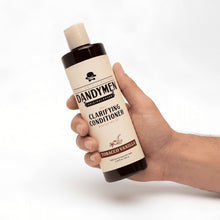 Daily use clarifying conditioner bottle held in hand, Tobacco Vanilla scent