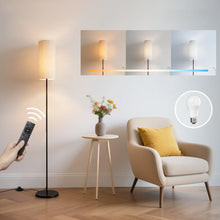 Black LED floor lamp with beige fabric shade and remote control, standing in living room