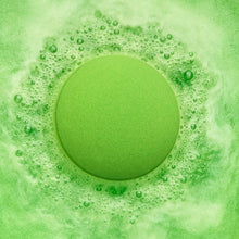 Green bath bomb surrounded by bubbling water