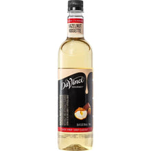 Syrup bottle with hazelnut flavor label, clear glass bottle and black cap.