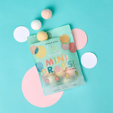 Tropical mini droplet bath bombs pouch with pastel bath bomb pieces floating around
