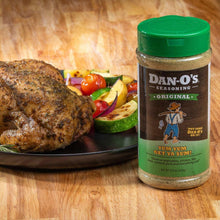 Dan-O's Original seasoning bottle beside roasted meat and vegetables