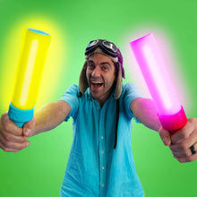 Light-up musical drumsticks, yellow and pink glowing tips, held by an adult