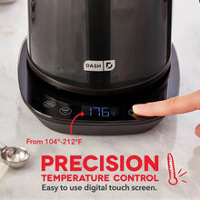 Black insulated electric kettle base with digital screen showing temperature, finger on panel