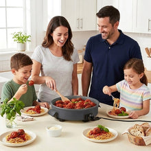 Family meal scene with gray electric skillet on table, serving spaghetti and meatballs