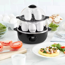 All-in-one egg cooker with clear lid steaming a tray of white eggs