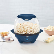 Blue tabletop popcorn maker with clear dome lid, popped popcorn in pot