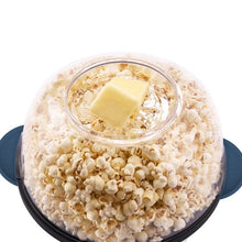 Blue popcorn maker with clear lid holding popcorn and a stick of butter