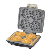 No-drip waffle maker with four Mickey-shaped waffles on plate, open lid, gray body.