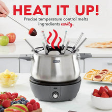 Stainless steel electric fondue pot with black top, upright forks, and temperature dial