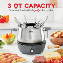 Stainless steel fondue pot with black top and upright fondue forks