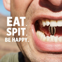 Close-up mouth with sunflower seed kernels, promotional snack message on graphic
