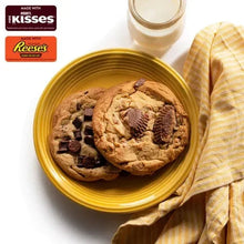 Chocolate cookies on gold plate with glass of milk and striped cloth