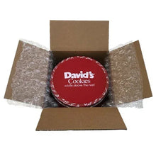 Gift box with red David's Cookies tin wrapped in protective tissue