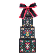 Four-tier candy treat tower with black patterned boxes and red-black bow on top