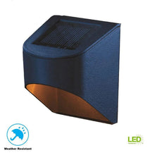 Solar downcast deck light, dark aluminum cube with amber lens and solar panel top
