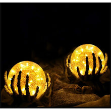 Glowing crackle glass LED globe lights with black bases in a dark setting