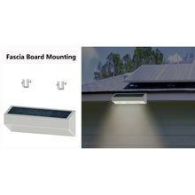 Solar fascia board lights with mounting hardware, glowing under house siding