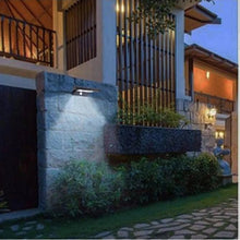 Solar wall light with motion sensor, black housing and illuminated frosted LED panel