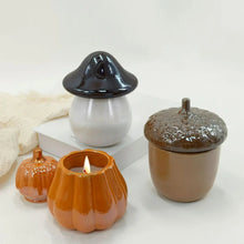 Orange ceramic pumpkin candle holder with lit wick and matching open rim