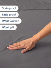 Gray fitted bed sheet fabric close-up with smooth surface