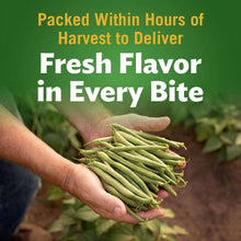 Fresh-cut green beans held in a hand; Del Monte can label visible.