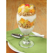 Glass dessert with fruit cocktail in light syrup and mixed fruit layers on a plate