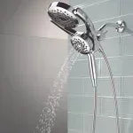 Chrome dual-head hand shower with flexible hoses, water spraying from two nozzles
