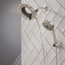 Two shower heads with water spray, chrome finish, including a handheld unit