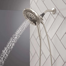 Hand shower with round spray head producing a strong water stream, wall-mounted
